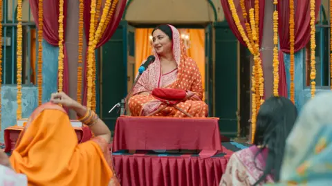 JioHotstar Kamlesh sits on a stage