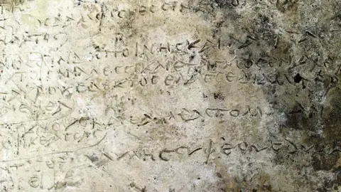 EPA A handout photo made available by the Greek Ministry of Culture shows a clay tablet with an engraved inscription of a rhapsody in Homer's "Odyssey" on 10 July 2018