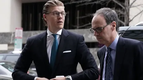 AFP Attorney Alex van der Zwaan (L), who formerly worked for the Skadden Arps law firm, arrives at a U.S. District Courthouse for his sentencing April 3, 2018 in Washington, DC.