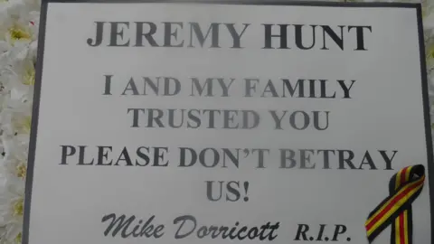 Sarah Dorricott Plaque placed outside Jeremy Hunt's constituency office following Mr Dorricott's death