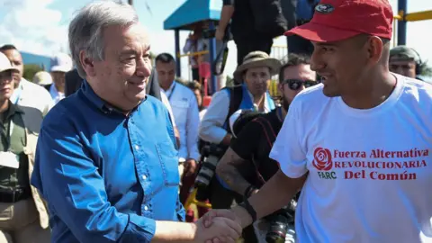 RAUL ARBOLEDA/AFP/Getty United Nations Secretary-General Antonio Guterres (L) shakes hands with a former member of the Revolutionary Armed Forces (Farc) in Colombia in the Mesetas municipality, Meta department, Colombia 14 January 2018