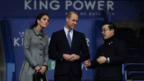 Aaron Chown/PA Wire Catherine, Prince William and Mr Aiyawatt inside the King Power Stadium