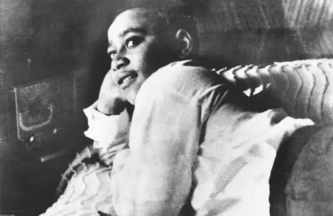 Getty Images A black and white file photo showing Emmett Till lying on his bed