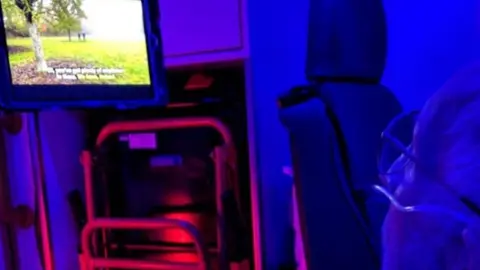 Sarah Jones Mervyn Jones inside an ambulance watching TV on an iPad