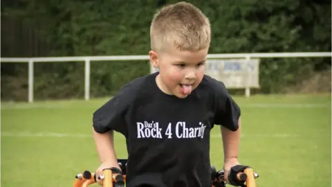 Oscar Cridge walking with a frame