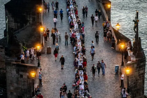 Gabriel Kuchta/Getty Images People dine at a 500m-long table on Charles Bridge