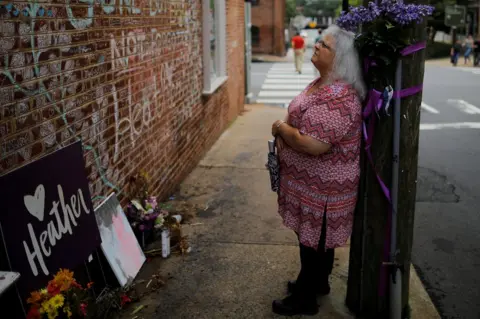 Reuters Susan Bro, mother of Heather Heyer, standing ahead of the anniversary at the place her daughter was killed