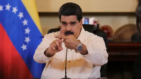 Reuters Venezuela's President Nicolas Maduro gestures toward the camera with crossed index fingers, during a meeting with ministers in Caracas