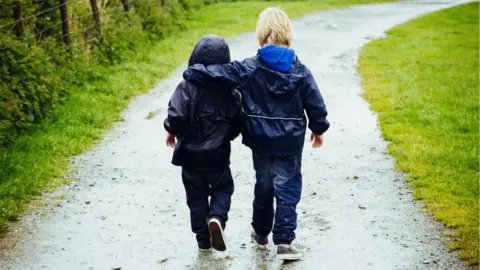 Getty Images Two brothers walking