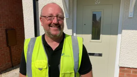 RAF veteran Kevin Chapman smiling outside his new home