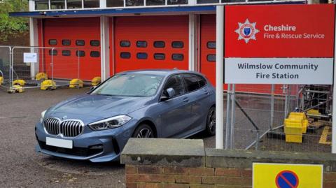 A car parked next to Wilmslow Community Fire Station