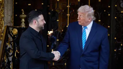 Getty Images Volodymyr Zelensky and Donald Trump smile and shake hands outside his property in Florida 