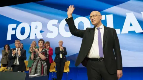 PA Media John Swinney after delivering his speech