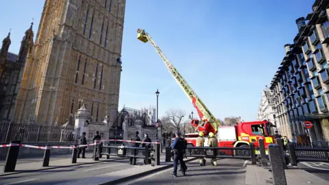 PA Media Emergency services including a fire engine with an extendable ladder at the Palace of Westminster in London after man with a Palestine flag climbed up Elizabeth Tower.