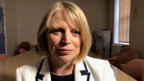 Health board boss Carol Shillabeer. She has blonde hair and is wearing a white jacket with black-edged lapels