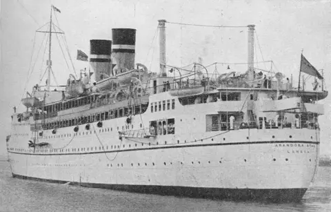 Getty Images An old picture of the ship the Arandora Star with two funnels and flags flying