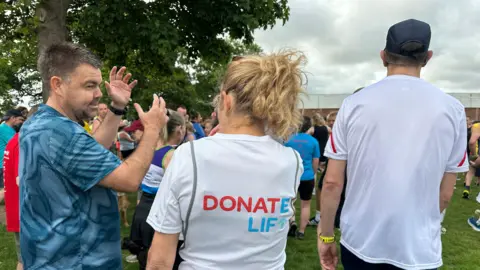 Karen Hodgson speaking to a man before the park run