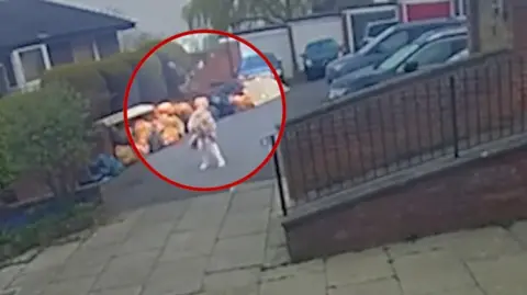 Doorbell camera captures moment buzzard flies over a woman in her dressing gown.