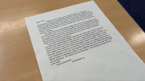 Annabelle's letter laid out on a light brown table