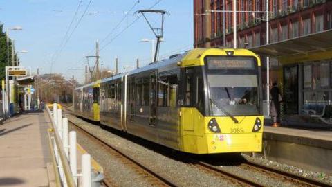 A tram at Shaw and Crompton Metrolink stop