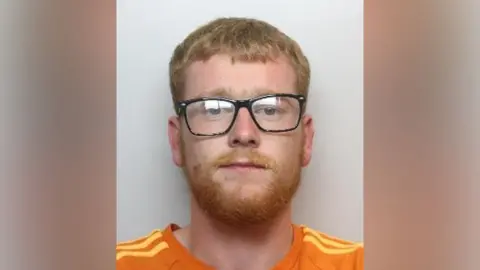 South Yorkshire Police A man wearing an orange top