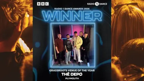 The Depo The image shows a promotional graphic announcing a major award win for a music venue. At the centre, a group of five people stand together in front of a lit backdrop, holding a trophy. Text at the top reads “BBC” and “RADIO 1 DANCE AWARDS 2026”, with a large “WINNER” headline above the group photo. Beneath the image, more text states “GRASSROOTS VENUE OF THE YEAR” and “THE DEPØ PLYMOUTH”. The left and right edges of the graphic feature an image of an audience at a live music event.