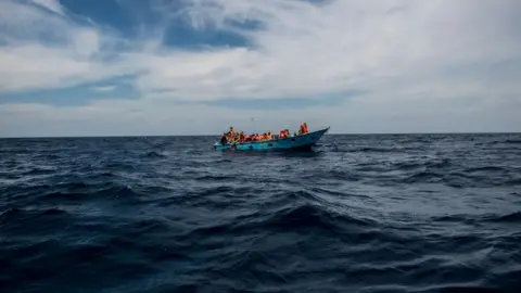 Getty Images Migrants on a ship in the Mediterranean Sea.