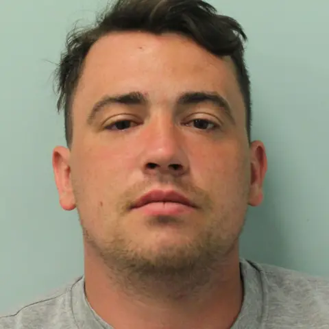 Met Police Custody image of Jordan McSweeney wearing a grey jumper