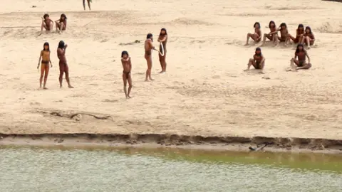 Members of the Mashco Piro Indigenous community, a reclusive tribe and one of the world's most withdrawn, gather on the banks of the Las Piedras river in Monte Salvado, in the Madre de Dios province, Peru, on 27 June 2024