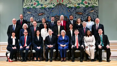 Getty Images Carney, pictured in the centre, with his new cabinet ministers