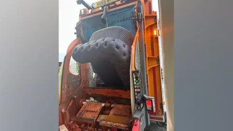 North Tyneside Council A sofa being loaded into a refuse vehicle.