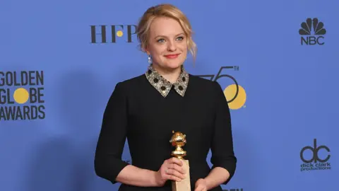 Getty Images Elisabeth Moss with her award