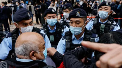 Reuters Supporters surrounded by Hong Kong police outside a court