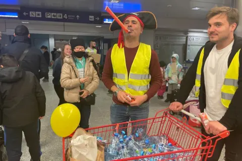 Volunteers handing out sweets and water