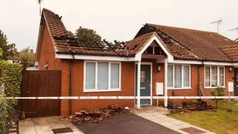 The bungalow with its roof missing