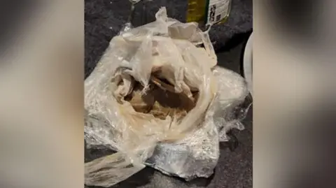 Police handout A plastic bag and cling film containing heroin seized in police raids.