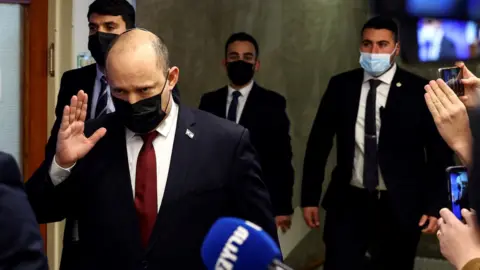 Reuters Israeli Prime Minister Naftali Bennett waves to reporters as he arrives at a cabinet meeting in Jerusalem on 6 March 2022