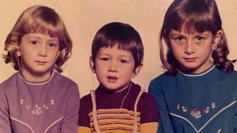 Family picture A childhood photograph of Ali with her younger brother and sister. Her siblings were born deaf, and Ali lost her hearing aged four.