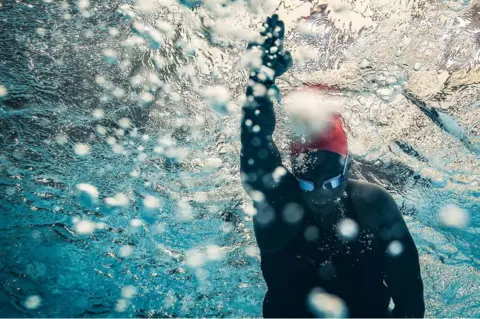 AFP Ugandan swimmer Clare Byarugaba poses during the swimming competition at the 2018 Gay Games edition at The Georges-Vallerey swimming pool in Paris on August 10, 2018. - Clare is a 31 year-old LGBT activist in Kampala. In 2014, a local newspaper put her on the front page presenting her as lesbian, forcing her to come out. It's her first time participating at the Gay Games. 'In my hometown, I can't take the bus, I have to drive everywhere inside of my car. I am afraid that people will recognize me. I was so proud to wear the uganda flag during the opening ceremony at this gat event. But now, I may face more problems when I will return home', Clare says.