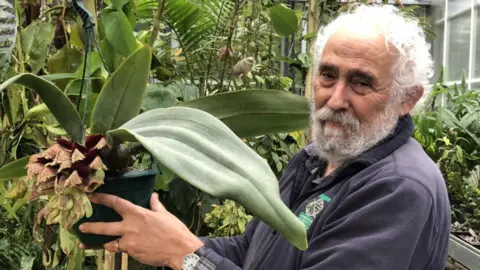 Cambridge University Botanic Garden Phil Gould with an orchid