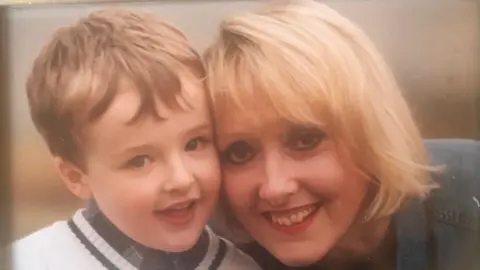 Supplied A childhood shot of Sam and his mum