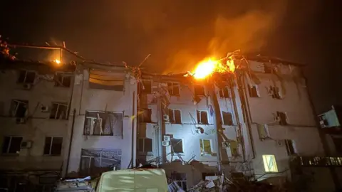 A hotel in Ukraine damaged and on fire after being struck by a Russian missile