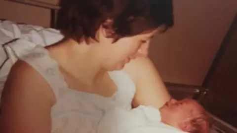 PA Media Barbara Palmer holding baby Lauren Palmer