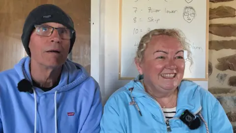 A couple from Lancashire I met were stunned by the change in the bothy from their first visit thirty years ago. The man is wearing a blue jumper and hat, and the woman has a blue coat on.