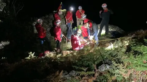 Members of Keswick Mountain Rescue Team rescuing an injured man