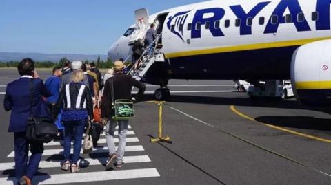 Passengers boarding a Ryanair plane