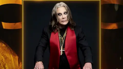 Brit Awards A photo of Ozzy Osbourne wearing a black jacket with large red lapels and several gold chains with crosses around his neck. He looks intensely at the camera.