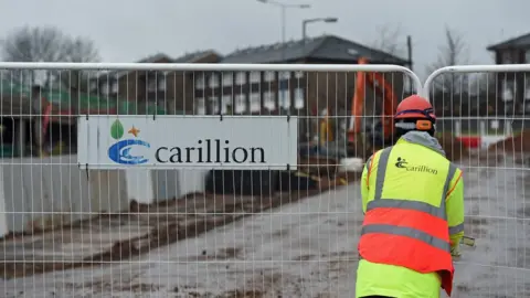 PA A Carillion sign at a building site in the West Midlands