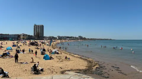 People sunbathing on the beach in Margate, Kent.