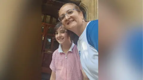 LDRS A mum and her daughter, who is in school clothes, smile for a selfie